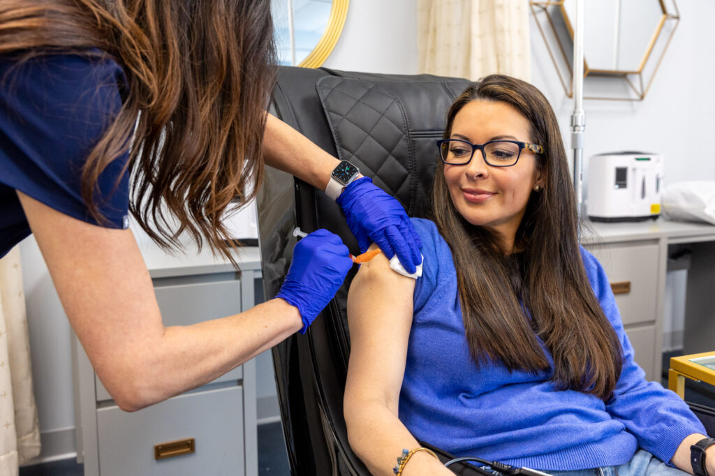 Close-up of a nurse injecting vitamins for immune system in Nashville into a female patient's arm