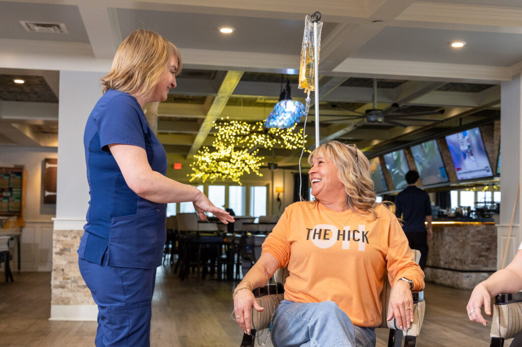 A patient smiles while talking to a nurse during IV hydration near Oak Hill, TN