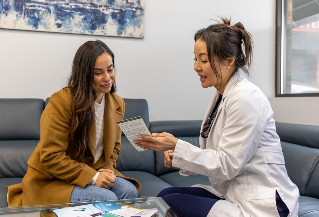 A female doctor sits with a female patient to discuss her options for an intravenous hangover cure in Nashville